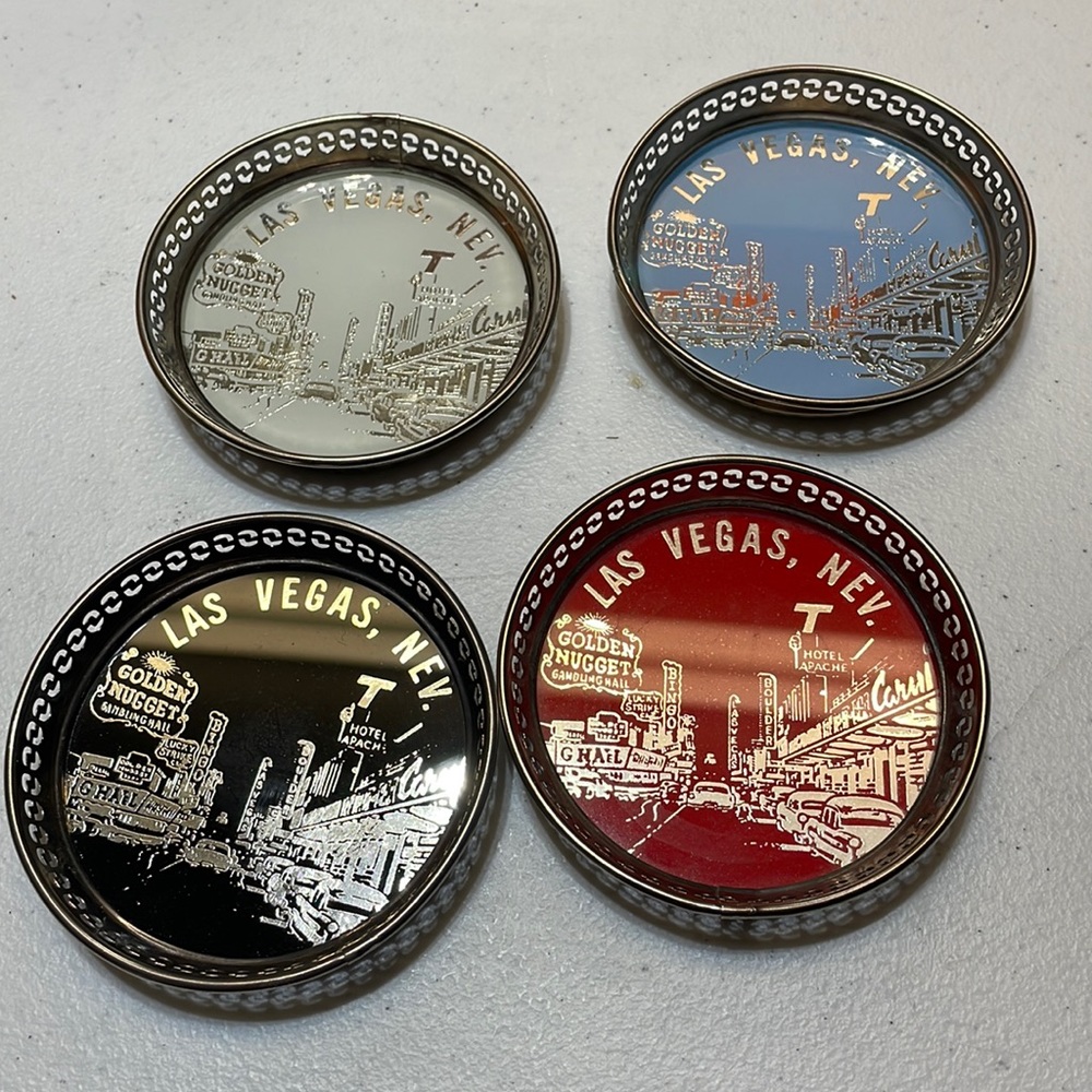 Four vintage metal coasters